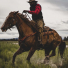 Filson Alaskan Guide Shirt Red Black on a horse