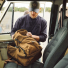 Filson Dryden Backpack 20152980 Whiskey on the front seat of a car
