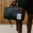 Topo Designs Quick Pack carrying in hand close-up