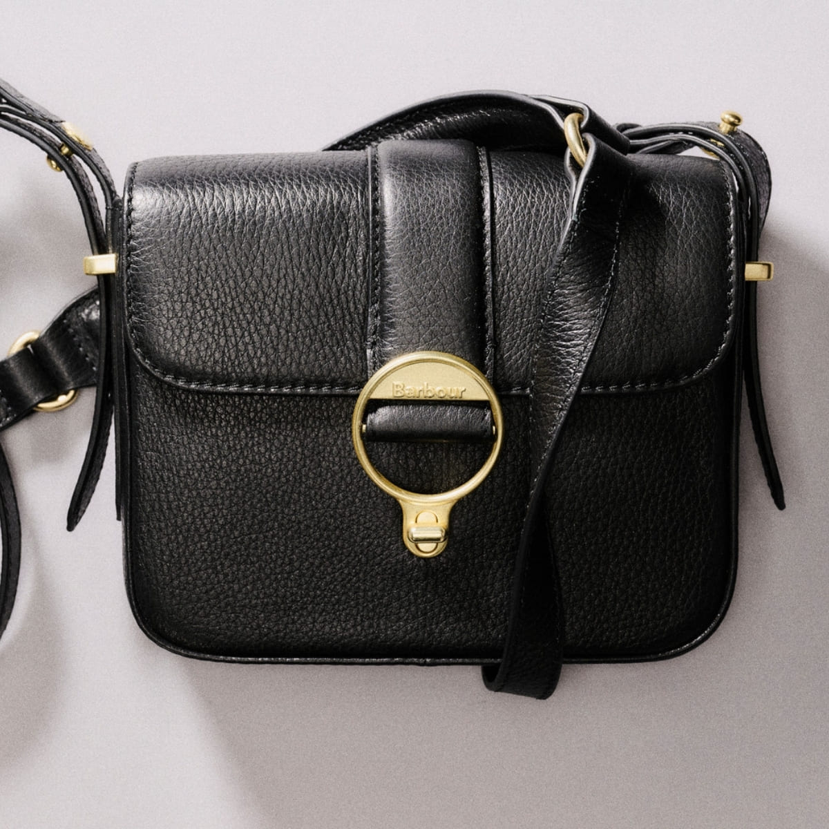 Barbour Mini Rosa Leather Crossbody Bag is a true eye-catcher that effortlessly combines style and functionality