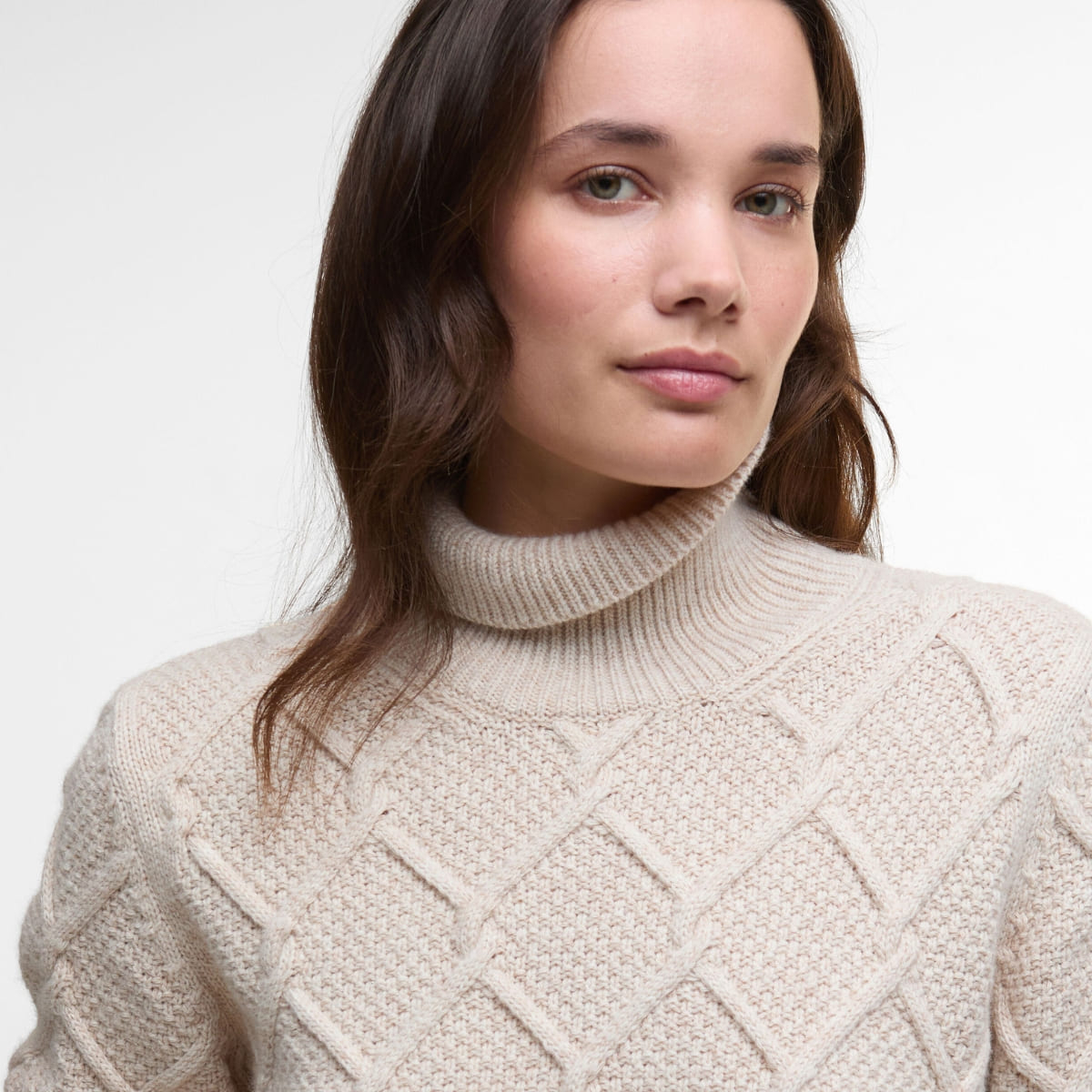 Barbour Burne Roll Neck Knitted Jumper in Oatmeal is a must-have elegant cable-knit sweater.