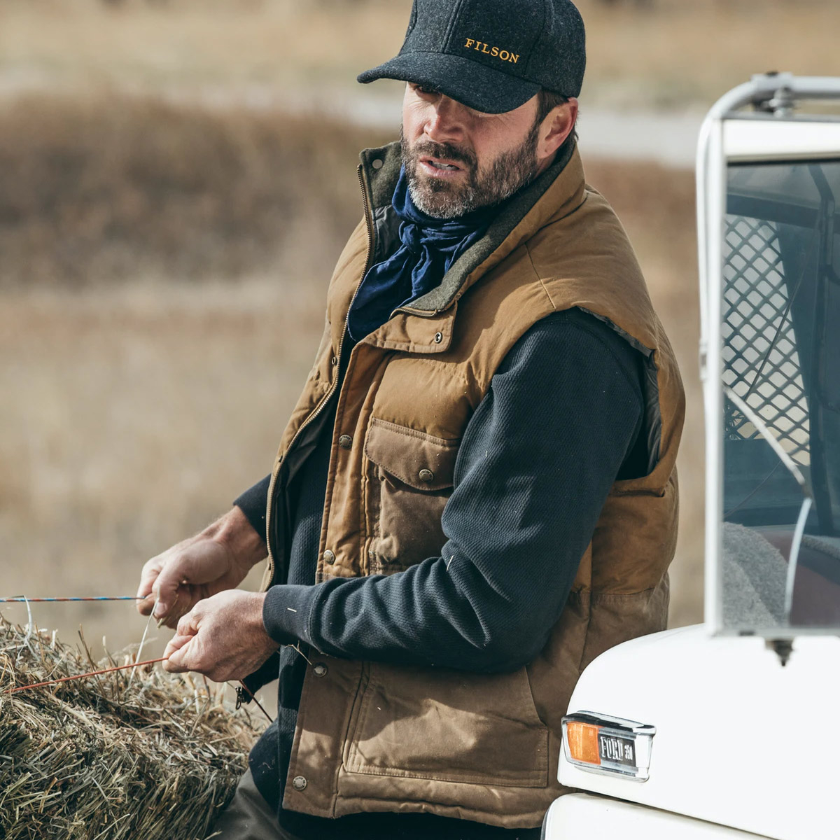 Filson Down Cruiser Vest Dark Tan, a warm, versatile layer that can be worn on its own or layered under a jacket