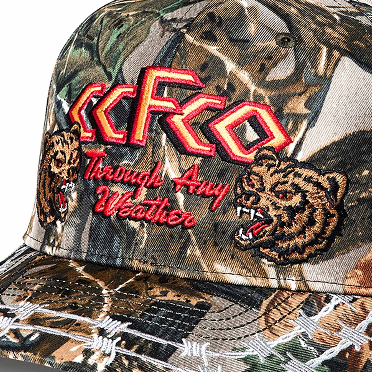 Filson Logger Cap Green Camo/Any Weather, a classic camo trucker cap, finished with a bold embroidered logo patch—built for style and durability
