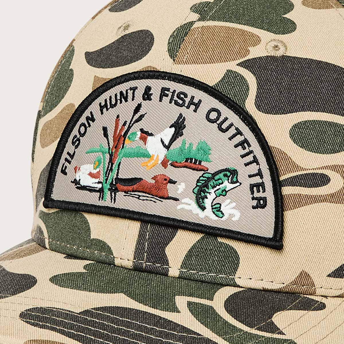 Filson Logger Cap Tan Camo/Hunt Fish, a classic trucker cap, finished with a bold embroidered logo patch—built for style and durability