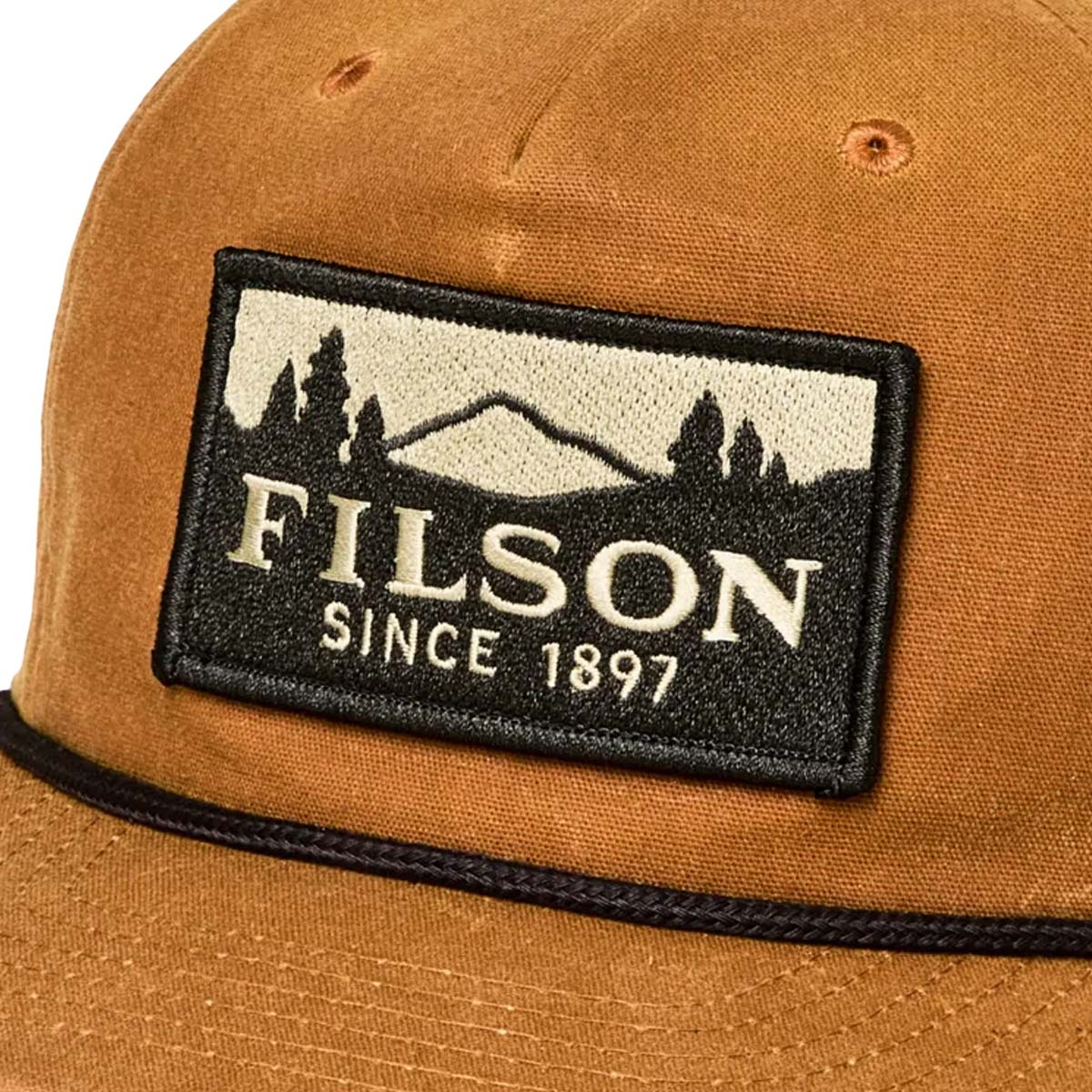 Filson Waxed Trucker Cap Gold Brown/Scenic, a classic waxed trucker cap, finished with a bold embroidered Filson scenic patch—built for style and durability Filson Waxed Trucker Cap Gold Brown/Scenic, a classic waxed trucker cap, finished with a bold embroidered Filson scenic patch—built for style and durability