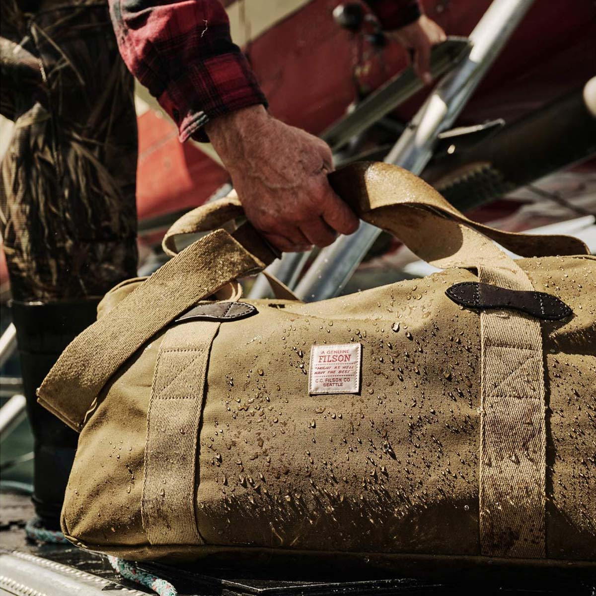 Filson Tin Cloth Medium Duffle Bag Dark Tan, a compact waxed-cotton duffle sized for overnight trips