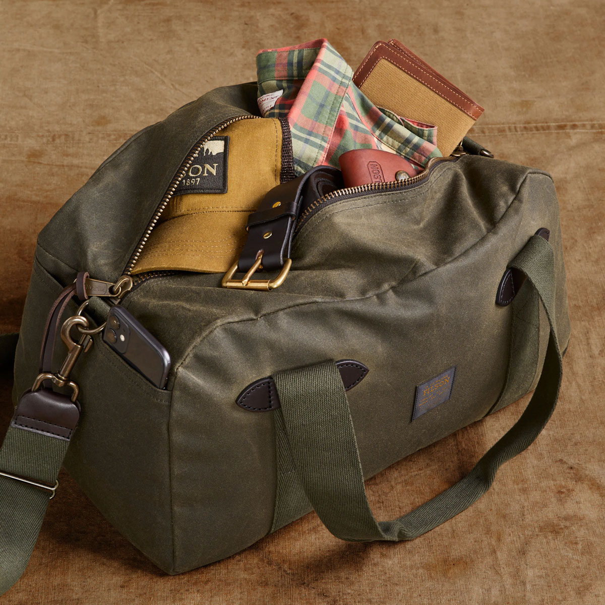 Filson Tin Cloth Small Duffle Bag Otter Green, a compact waxed-cotton duffle sized for overnight trips