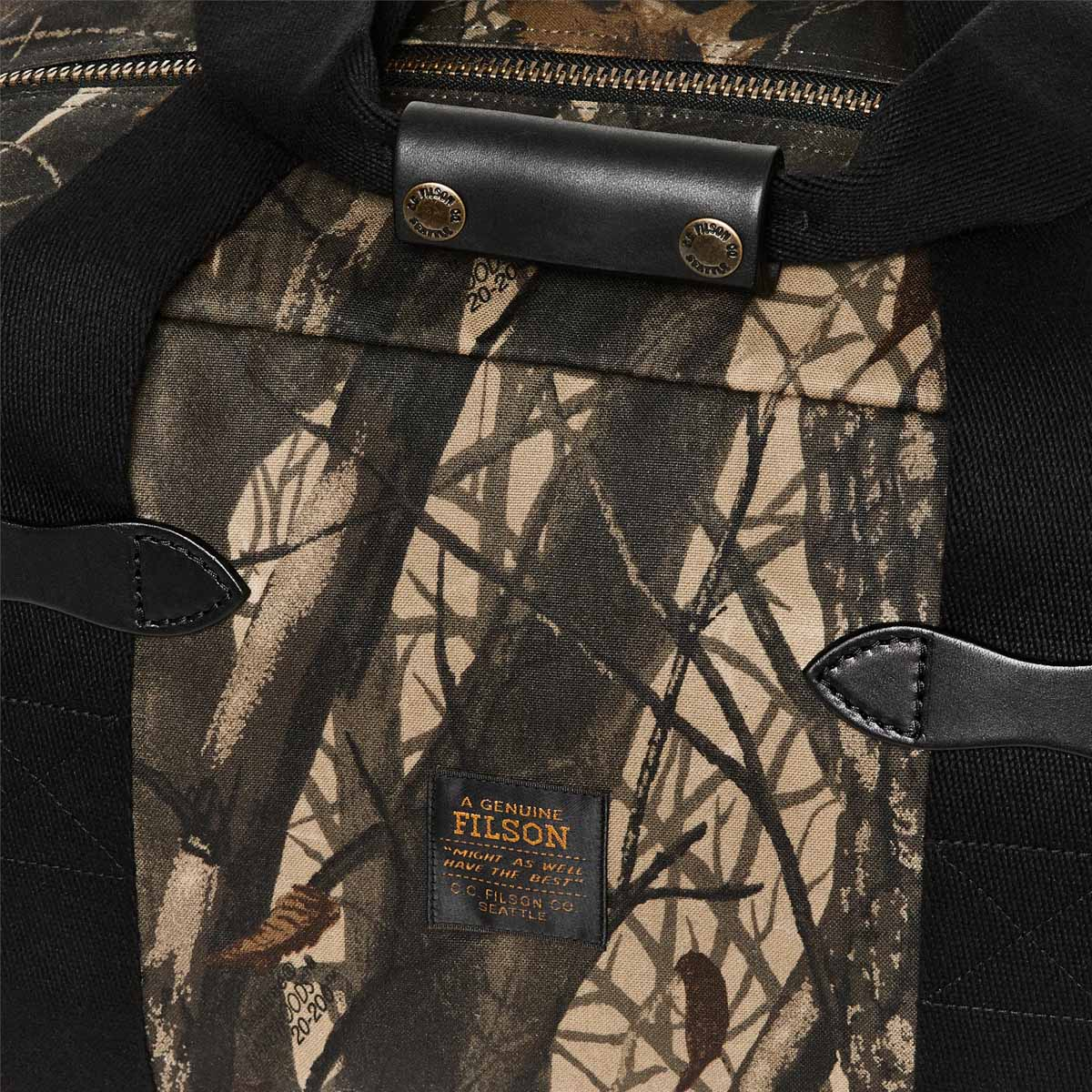 Filson Tin Cloth Small Duffle Bag Realtree Hardwoods Camo, a compact waxed-cotton duffle sized for overnight trips