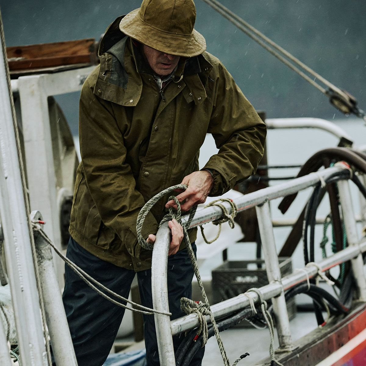 Filson Foul Weather Jacket Dark Tan, a classic waxed-cotton raincoat with improved fit and sturdy fabric