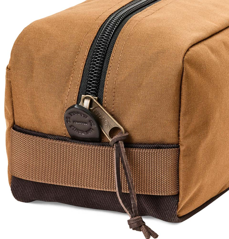 Filson Travel Pack Whiskey, made of tear-resistant ballistic nylon and reinforced with Filson's famous Rugged Twill