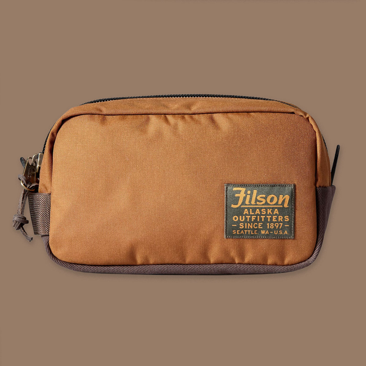 Filson Travel Pack Whiskey, made of tear-resistant ballistic nylon and reinforced with Filson's famous Rugged Twill